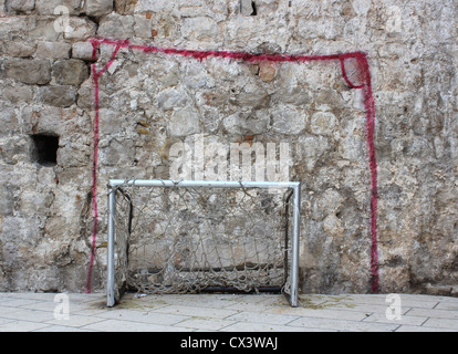 Painted and real goalposts - street football game Stock Photo