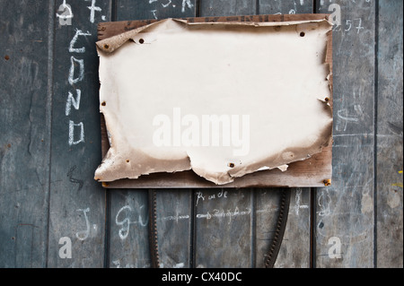 Sheet of paper on a wooden fence Stock Photo