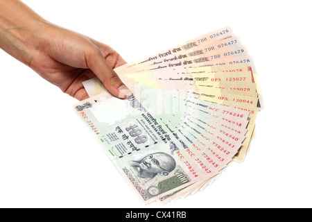 Hand holding Indian rupee notes against white background Stock Photo