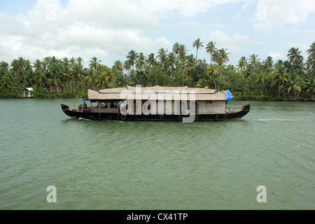 A traditional houseboat sailing through Ashtamudi lake Stock Photo
