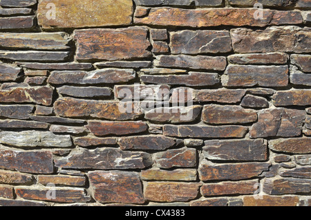 Denial of access, computer security / firewall concept. Section of retaining garden wall. Cornwall. Irregular stonework. For UK construction sector. Stock Photo