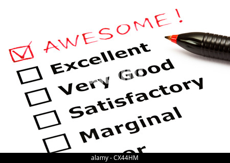 Awesome added on top of a customer evaluation form with red pen Stock Photo