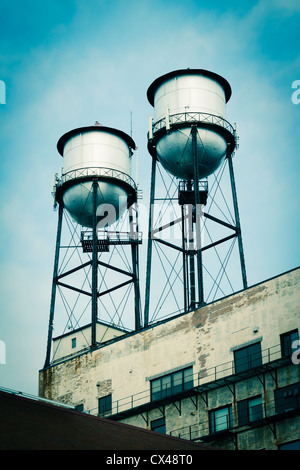 Water towers on top of old industrial buildings. Stock Photo