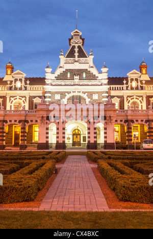 Dunedin Railway Station, the main entrance, illuminated at twilight, Otago, New Zealand. Stock Photo