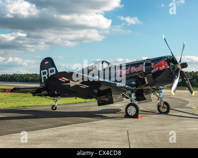 Chance Vought F4U Corsair fighter aircraft standing on the runway with dramatic clouds - sunny. High resolution Hasselblad digit Stock Photo