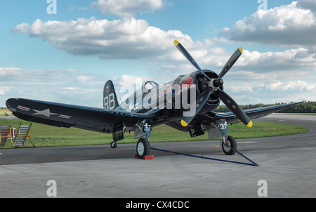 Chance Vought F4U Corsair fighter aircraft standing on the runway with dramatic clouds. High resolution Hasselblad digital shot. Stock Photo