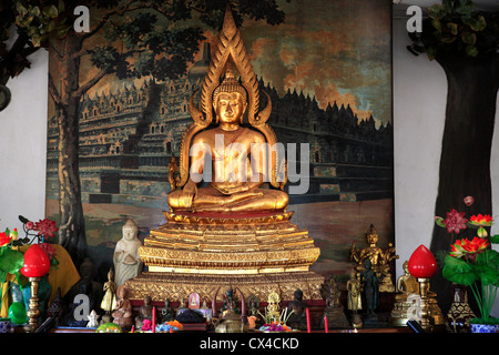 A golden Buddha statue in one of the worship rooms at the Brahmavihara Arama Buddhist Monastery Stock Photo