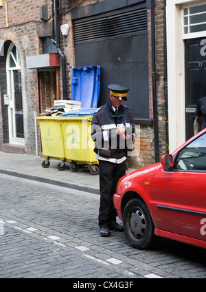 Traffic warden issuing parking ticket in Liverpool, England, UK Stock Photo