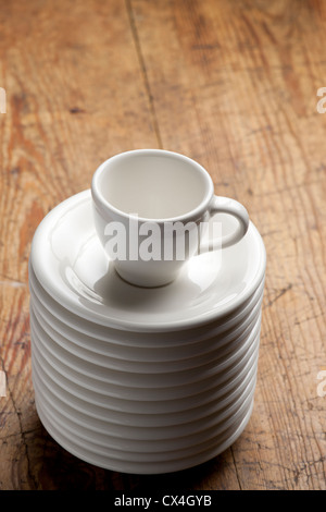 Empty coffee cup on the stack of saucers Stock Photo