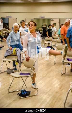 Senior women and men work out during a chair exercise class at a senior center in Tustin, CA. Stock Photo