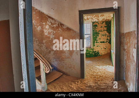 Interior room in Kolmanskop, a ghost mining town in Namibia, Africa. The desert has reclaimed the town after it was abandoned.