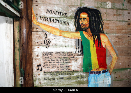 Bob Marley mural painted on wall of abandoned wooden building. Stock Photo