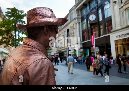 Street and Shops of Liverpool One with Statuesque Street performer, Merseyside, UK Stock Photo