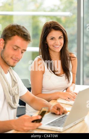 High-school students working on laptops in study academic library campus Stock Photo