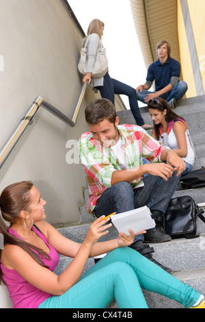 Students talking relaxing on school steps teens break smiling campus Stock Photo
