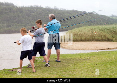Boy casting fishing line into lake on a summer day Stock Photo - Alamy