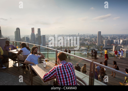 Tourists on the observation deck of the Marina Bay Sands SkyPark which sits 200 metres above the city. Marina Bay, Singapore Stock Photo