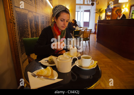Female in her 30s having coffee and cake Cafe A Blikle old town Krakow city Malopolska region Poland Europe Stock Photo