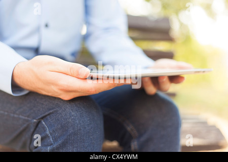 Businessman Using Tablet Computer in park Stock Photo