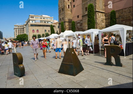 Barcelona people. Tourists strolling on plaza with market stalls in Barcelona Catalonia Spain ES Stock Photo