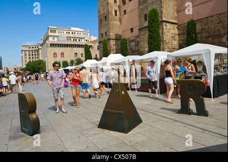 Barcelona people. Tourists strolling on plaza with market stalls in Barcelona Catalonia Spain ES Stock Photo