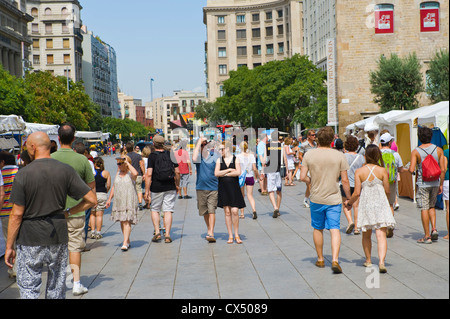 Barcelona people. Tourists strolling on plaza with market stalls in Barcelona Catalonia Spain ES Stock Photo