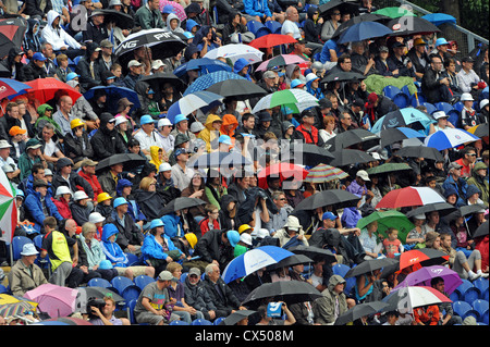 Umbrellas come out as heavy rain starts during the cricket Twenty20 Finals Day 2012 at the Swalec Stadium in Cardiff Stock Photo