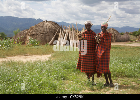 Two men in front of traditional straw oval huts, Erbore, Omo Valley, Southern Ethiopia, Africa Stock Photo