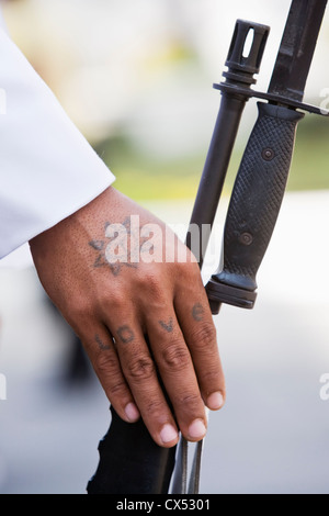 The word 'love' tattooed on a soldier's hand. Grand Palace, Bangkok, Thailand Stock Photo