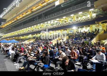 Crowds of spectators in grandstand at horse racing in Happy Valley stadium in Hong Kong Stock Photo