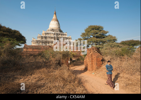 Girl walking through through outer gate, Dhamma-Yangyi Temple (Dhammayangyi), Bagan, Myanmar (Burma) Stock Photo