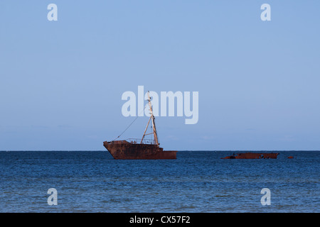 Rusty old ship wreck in sea Stock Photo