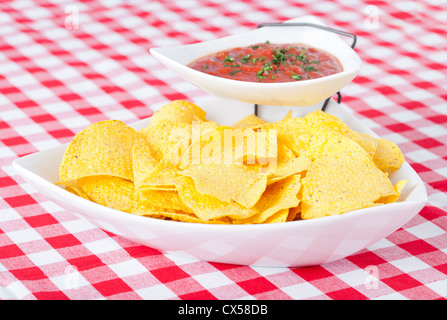 Chips and salsa on checkered tablecloth Stock Photo