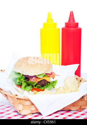 Bacon cheeseburger on a table with ketchup and mustard Stock Photo