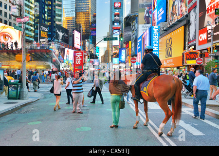 Tourists and police in Times Square. Stock Photo