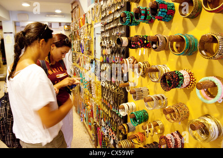 Two young women shopping in a gift store, Stone town Zanzibar Africa Stock Photo