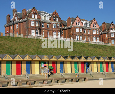 A colourful line of traditional beach huts adorn the South Beach and seafront at Lowestoft in Suffolk, England Stock Photo