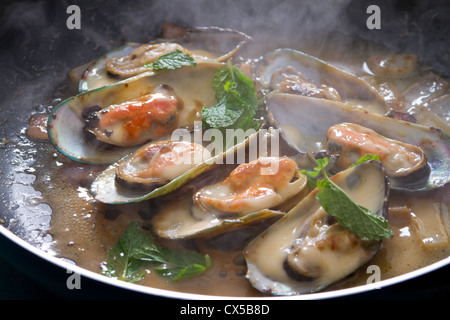 fresh mussels cooking in frying pan Stock Photo