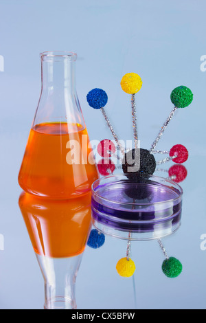 orange flask and purple petri dish with molecular model and reflections Stock Photo