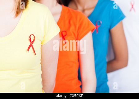 group of young people with red ribbon on their chest for AIDS HIV awareness Stock Photo