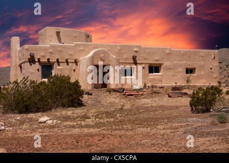 Adobe house in Nevada desert with dramatic sunset Stock Photo