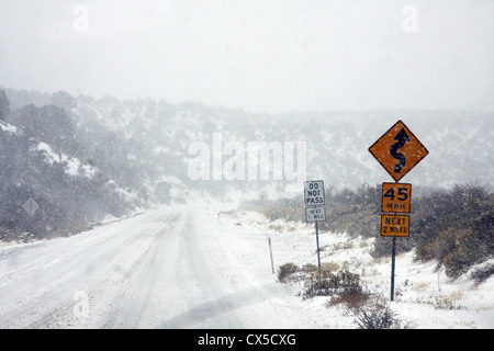 Snow road Mount Charleston, Nevada with traffic signs Stock Photo