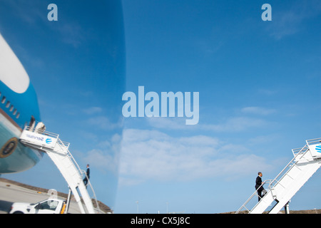 US President Barack Obama is reflected off a window as he boards Air Force One April 22, 2011 at Los Angeles International Airport in Los Angeles, CA. Stock Photo