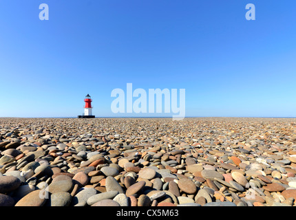 Lighthouse with Beach Pebbles in foreground. Location - Point of Ayre on the Isle of Man Stock Photo