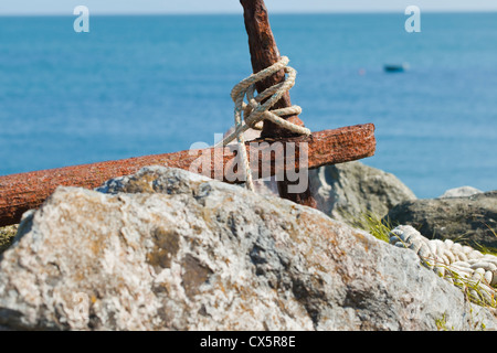 Rusty Anchor Above the Beach, Beesands, Start Bay, South Devon, UK Stock Photo
