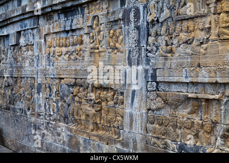 Wall Relief on the Buddhist temple Borobudur in Indonesia Stock Photo