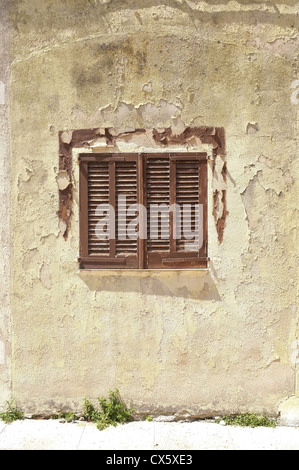 a majorcan shuttered window with an old flaky wall Stock Photo