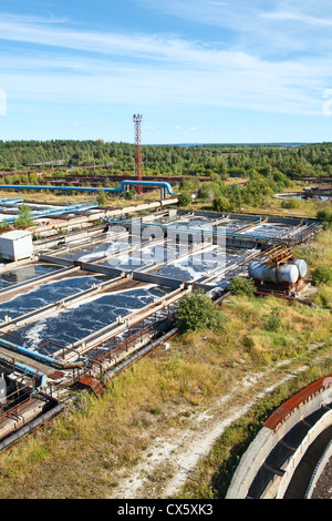 Industrial water treatment plant in evergreen forests. Water aeration on recycling tanks Stock Photo