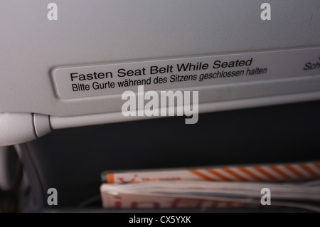 Fasten seat belt sign on airplane seat Stock Photo