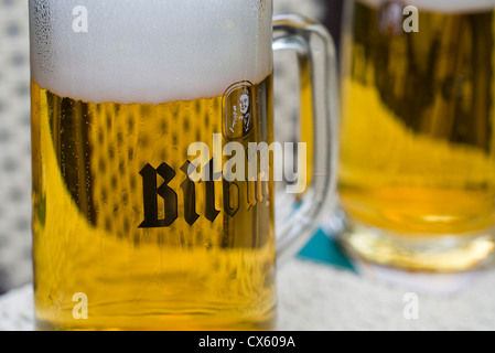 Two glasses of German Bitburger beer on a table Stock Photo